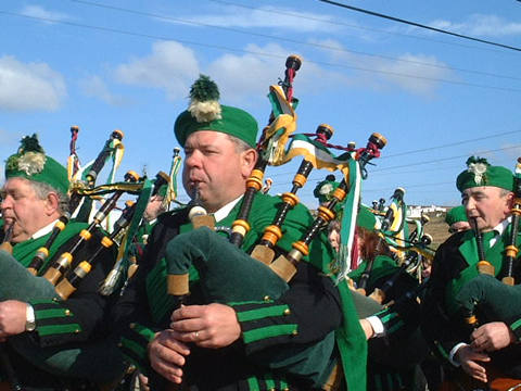 Three pipers playing